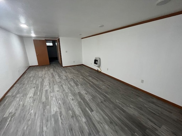 interior space featuring heating unit and hardwood / wood-style floors