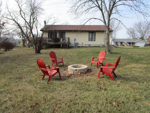 exterior space with a yard, a fire pit, and a wooden deck