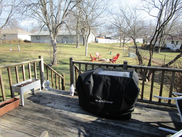 wooden deck featuring a yard and area for grilling