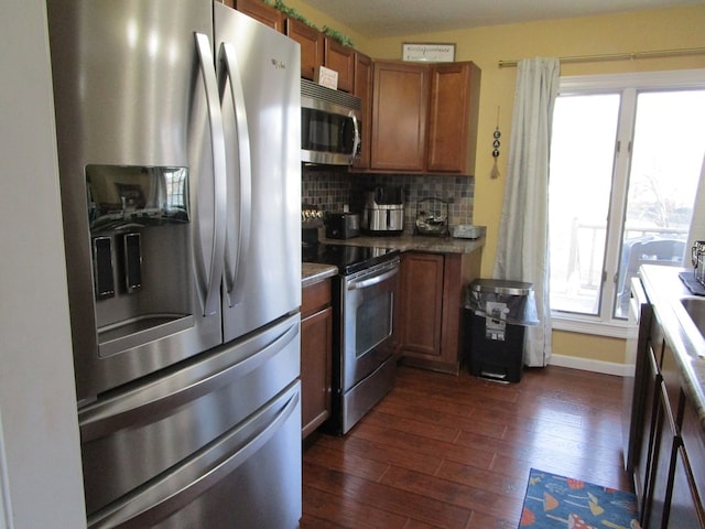 kitchen featuring backsplash, stainless steel appliances, and dark hardwood / wood-style floors