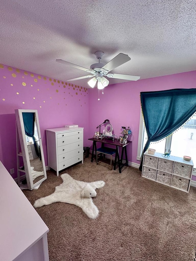 carpeted bedroom featuring ceiling fan and a textured ceiling