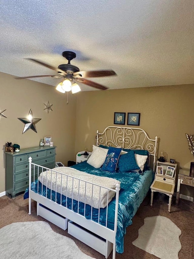 carpeted bedroom with a textured ceiling and ceiling fan