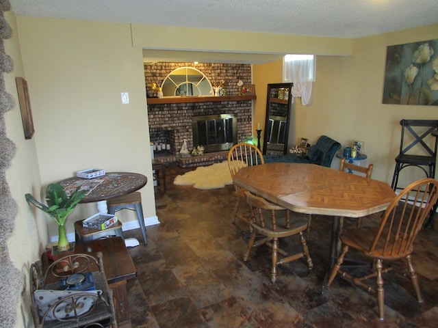 dining space with a brick fireplace