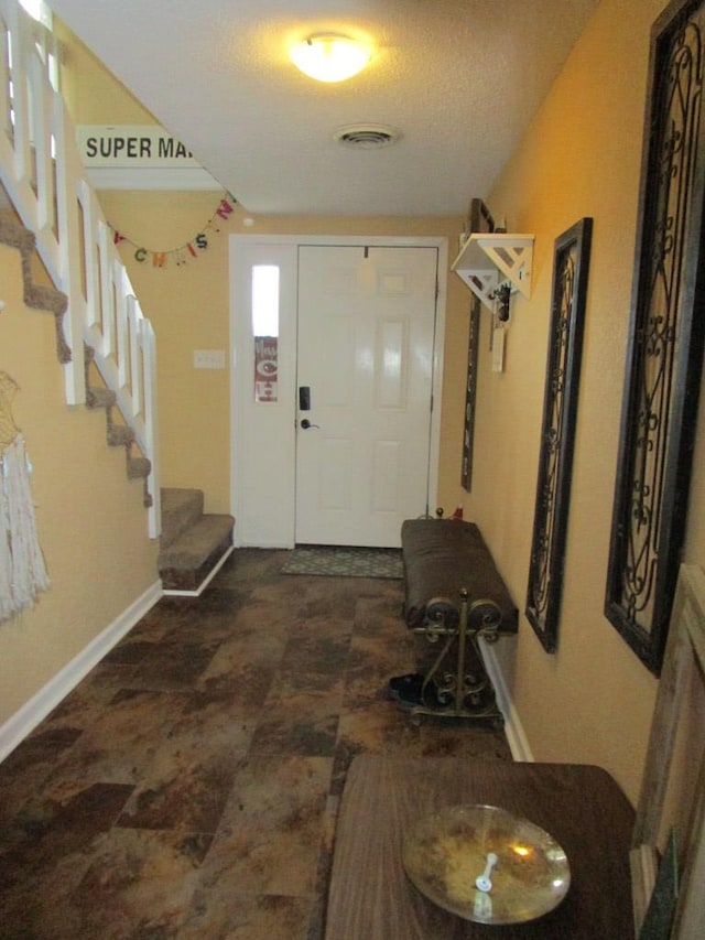 entryway with a textured ceiling