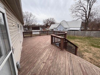 wooden terrace with a lawn