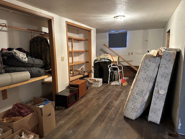 interior space featuring a textured ceiling and dark hardwood / wood-style flooring