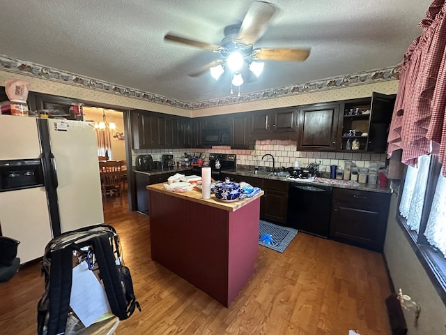 kitchen featuring black appliances, ceiling fan with notable chandelier, a textured ceiling, and hardwood / wood-style flooring