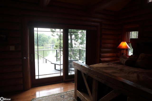 doorway featuring log walls and wood finished floors