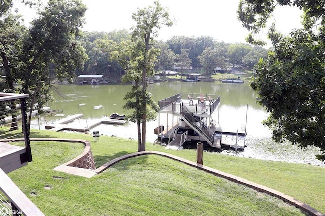 dock area with a yard and a water view