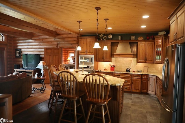 kitchen featuring decorative light fixtures, custom range hood, glass insert cabinets, open floor plan, and black appliances