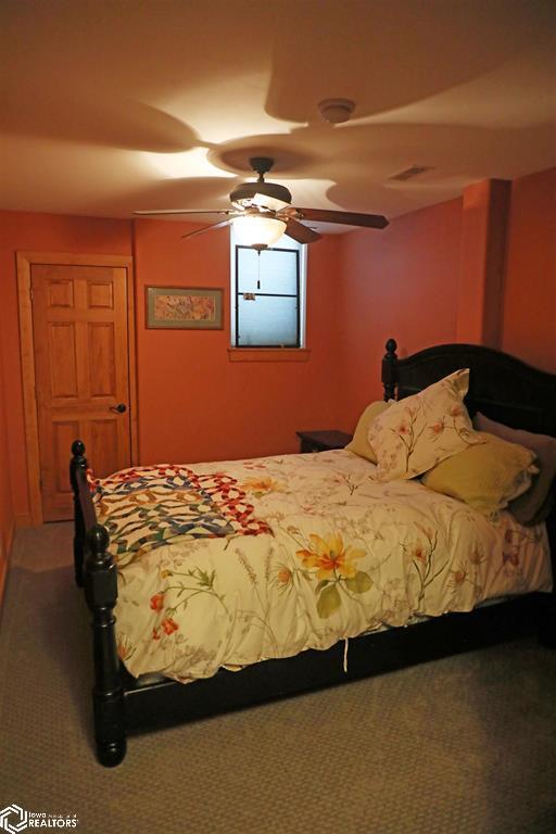 carpeted bedroom with a ceiling fan