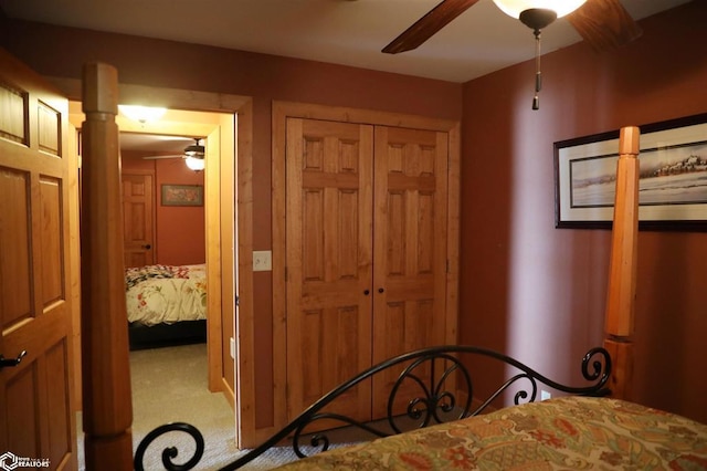 carpeted bedroom with a ceiling fan and a closet