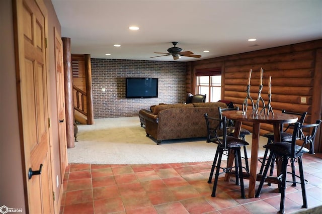 dining area with recessed lighting, brick wall, a ceiling fan, stairs, and log walls