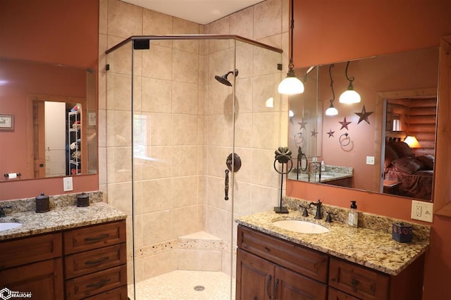 bathroom with two vanities, a sink, and a shower stall