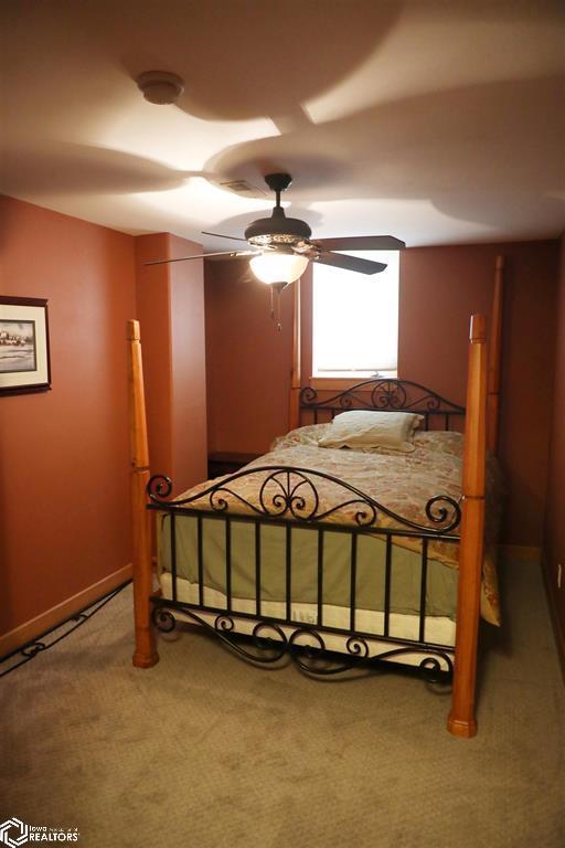 carpeted bedroom featuring a ceiling fan