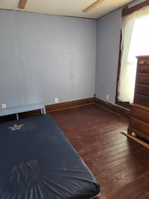 605 High St, Linneus, MO 64653 - unfurnished bedroom with hardwood / wood-style floors and baseboards