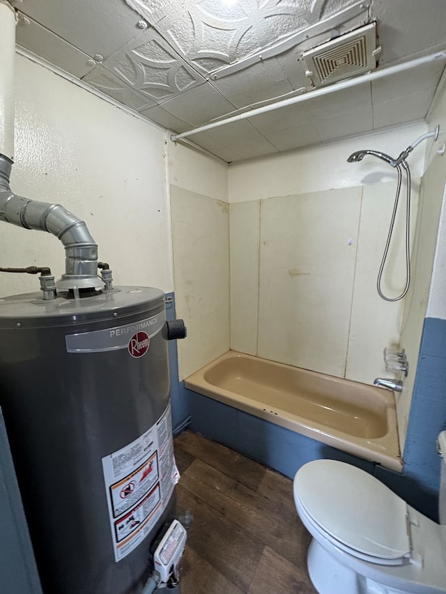 bathroom featuring toilet, hardwood / wood-style floors, bathtub / shower combination, and gas water heater