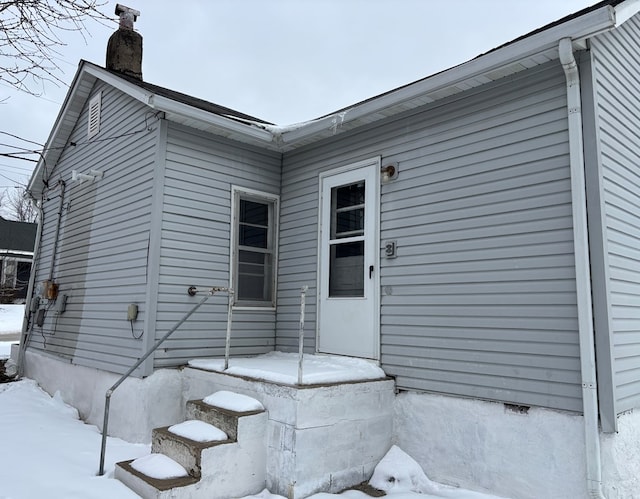 view of snow covered property entrance