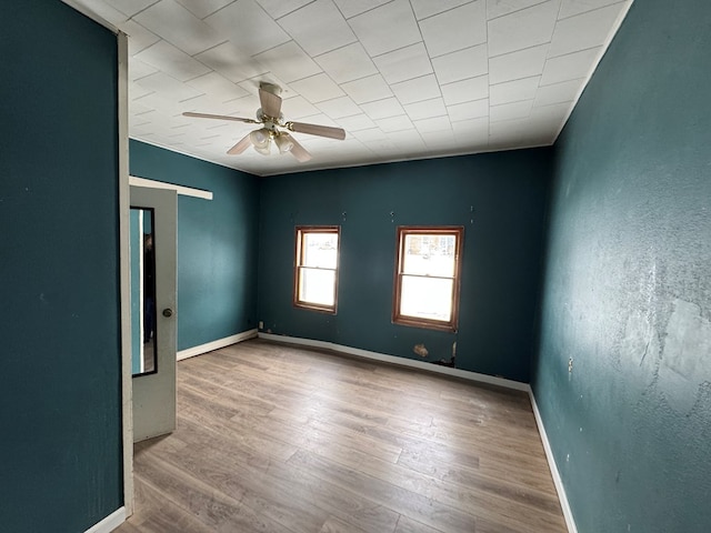 empty room featuring ceiling fan and wood-type flooring