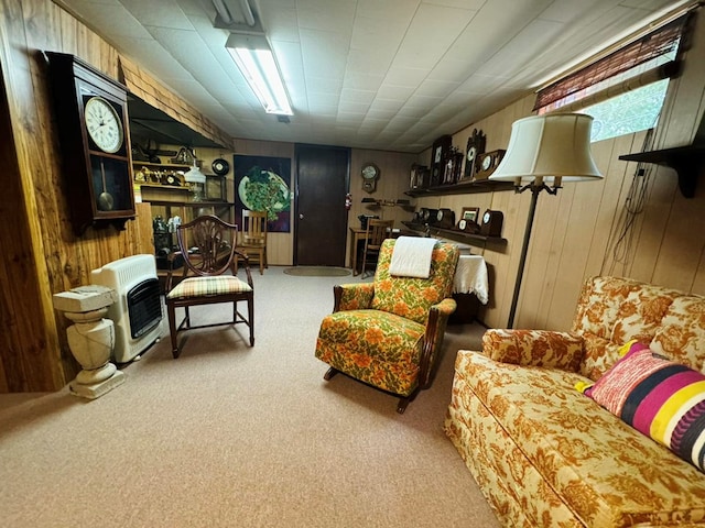 living area with wood walls, carpet floors, and heating unit