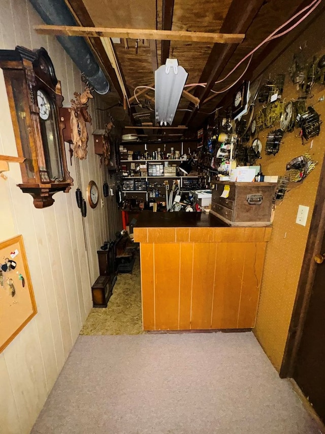 bar with a workshop area and light carpet