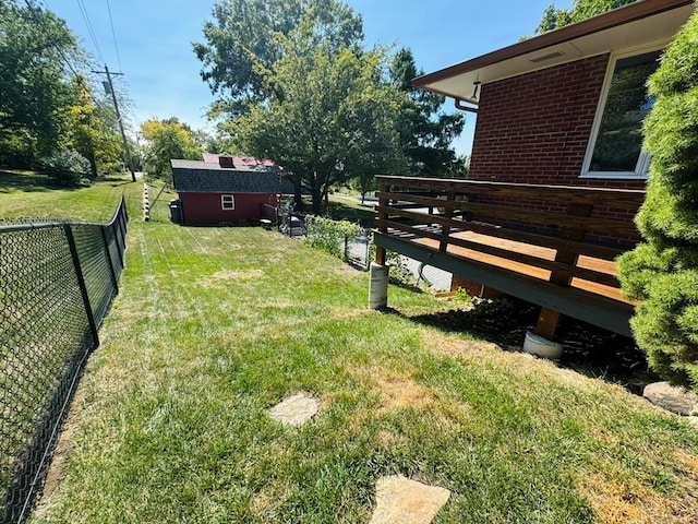 view of yard with a wooden deck and an outbuilding