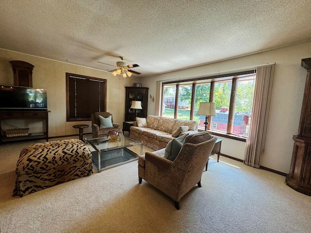 living room with a textured ceiling, light colored carpet, and ceiling fan