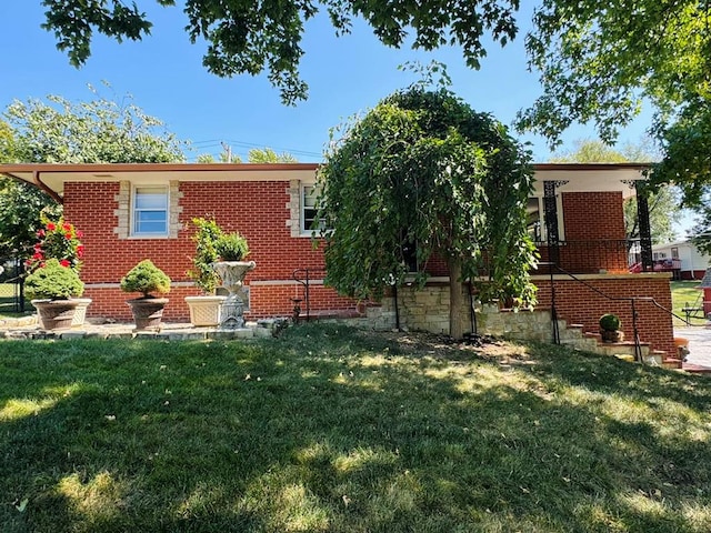 rear view of property with a lawn