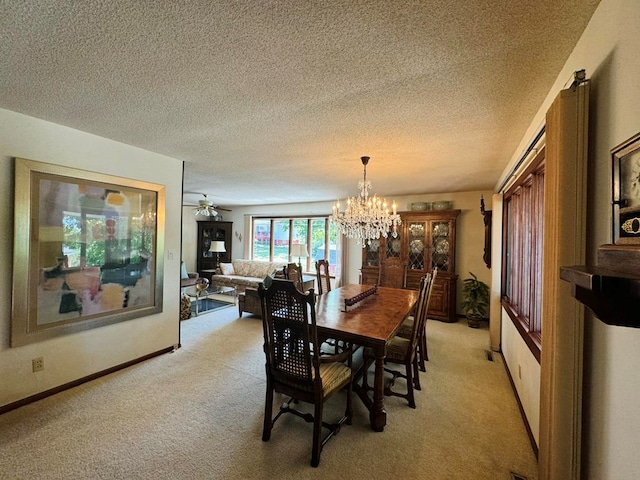 carpeted dining area with a textured ceiling and ceiling fan with notable chandelier