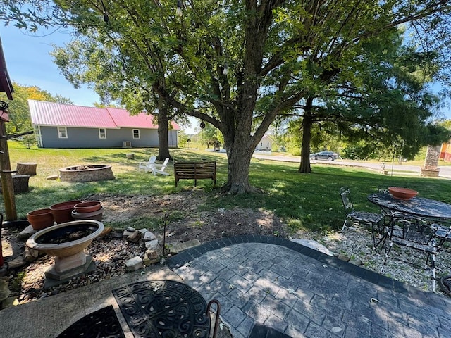 view of yard featuring a patio area and an outdoor fire pit