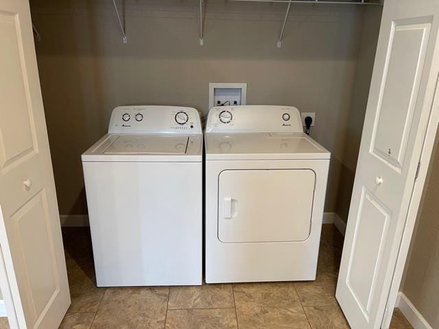 laundry room featuring independent washer and dryer and light tile patterned floors