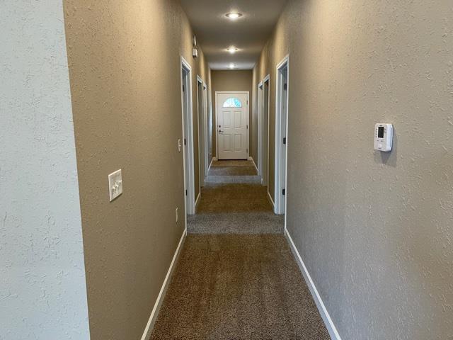 corridor featuring carpet flooring