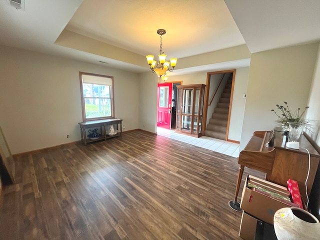 dining area with a notable chandelier and dark hardwood / wood-style floors