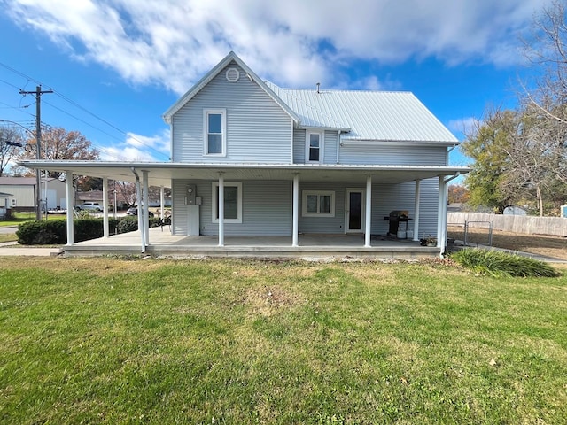 back of property featuring a lawn