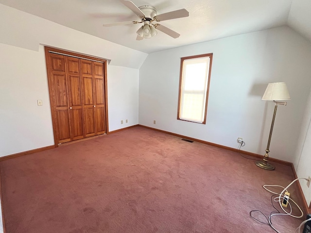 interior space with carpet flooring, ceiling fan, and lofted ceiling