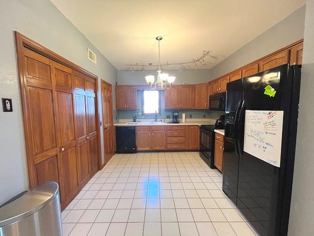 kitchen featuring a notable chandelier, black appliances, sink, light tile patterned floors, and decorative light fixtures