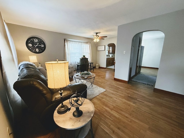 1316 Porter, Kirksville, MO 63501 - living room with a ceiling fan, arched walkways, baseboards, and wood finished floors