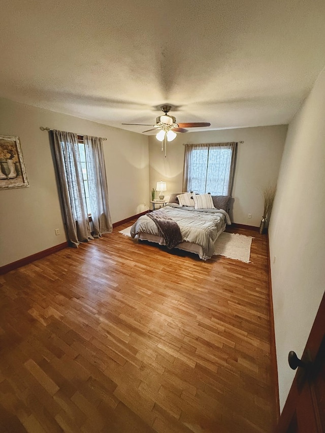 1316 Porter, Kirksville, MO 63501 - unfurnished bedroom featuring a ceiling fan, a textured ceiling, baseboards, and wood finished floors