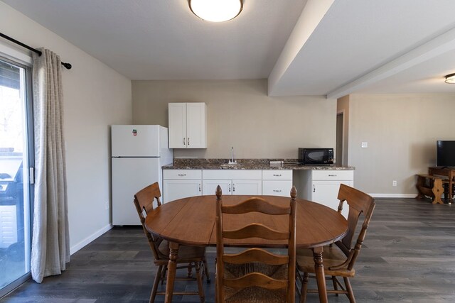500 W Santa Fe St, Marceline, MO 64658 - dining area with dark hardwood / wood-style flooring and sink
