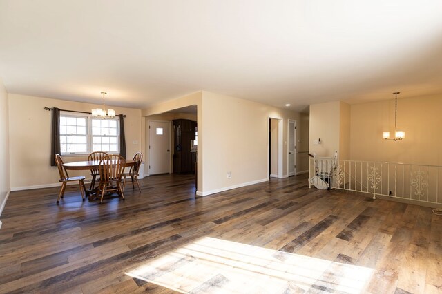 500 W Santa Fe St, Marceline, MO 64658 - dining room featuring a notable chandelier and dark wood-type flooring