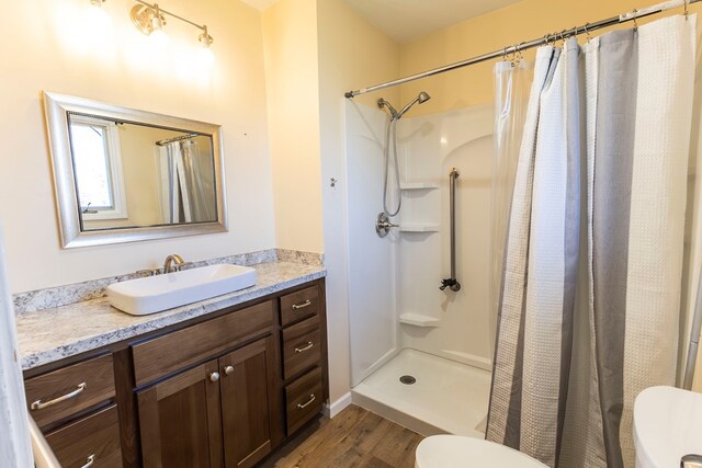 500 W Santa Fe St, Marceline, MO 64658 - bathroom with vanity, toilet, wood-type flooring, and walk in shower
