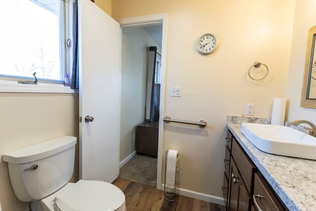 500 W Santa Fe St, Marceline, MO 64658 - bathroom with toilet, vanity, and hardwood / wood-style flooring