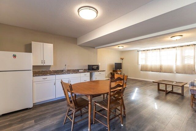500 W Santa Fe St, Marceline, MO 64658 - dining room with a textured ceiling, sink, and dark wood-type flooring