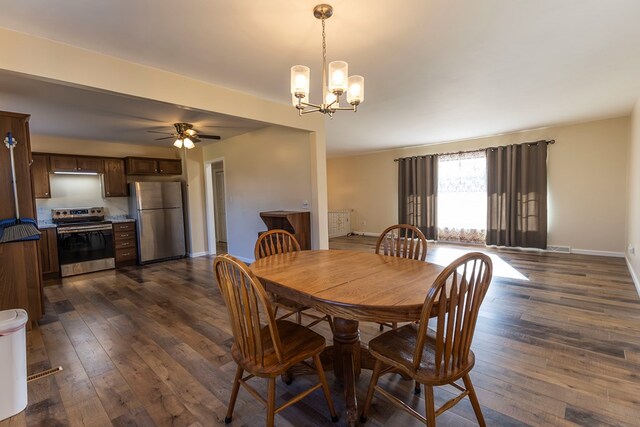 500 W Santa Fe St, Marceline, MO 64658 - dining area with ceiling fan with notable chandelier and dark hardwood / wood-style flooring