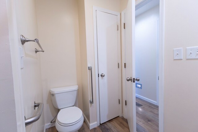 500 W Santa Fe St, Marceline, MO 64658 - bathroom featuring wood-type flooring and toilet