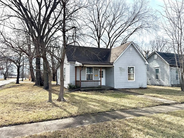 single story home featuring a front lawn and covered porch