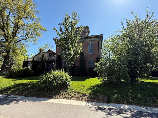 101 E Burton St, Kirksville, MO 63501 - view of property exterior featuring brick siding and a lawn