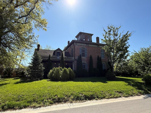 101 E Burton St, Kirksville, MO 63501 - view of property exterior featuring a chimney, a yard, and brick siding