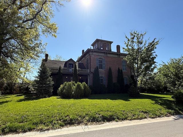 101 E Burton St, Kirksville, MO 63501 - view of side of home with a chimney, a lawn, and brick siding