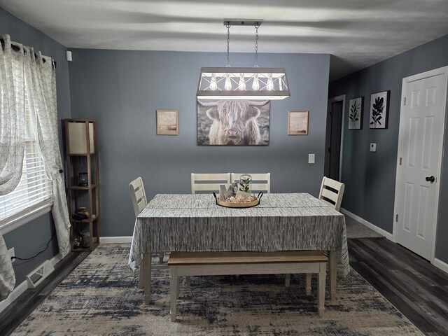 1701 Boyd, Chillicothe, MO 64601 - dining room featuring plenty of natural light and dark wood-style flooring